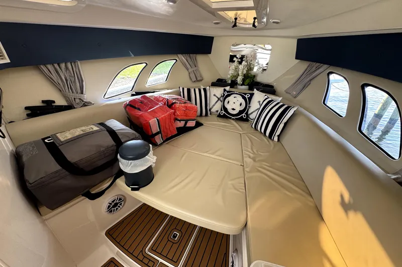  Yacht Photos Pics 2014 Intrepid 400 Cuddy cabin interior with cushions and bags, featuring elegant decor.