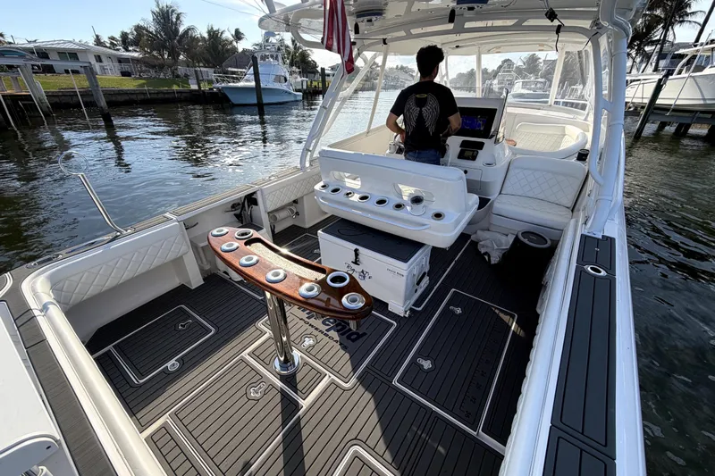  Yacht Photos Pics 2014 Intrepid 400 Cuddy boat interior with helm, seating, and fishing rod holders.