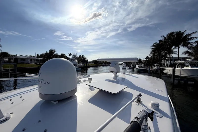  Yacht Photos Pics 2014 Intrepid 400 Cuddy boat docked under a sunny sky with palm trees.