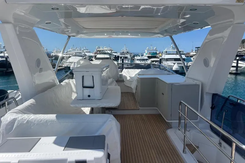 Al&Iacute;a Yacht Photos Pics Luxurious 2025 Azimut Fly 60 yacht interior with marina view, featuring sleek design and spacious seating.
