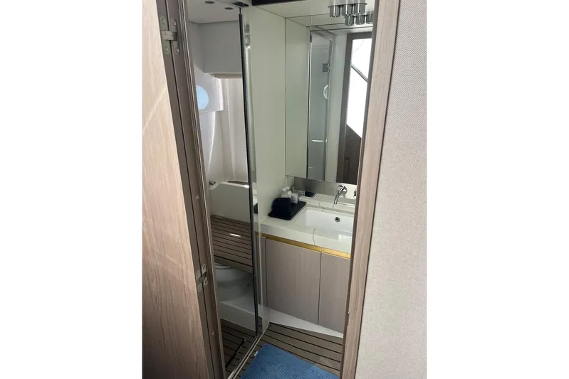 Al&Iacute;a Yacht Photos Pics Bathroom interior of 2025 Azimut Fly 60 yacht, featuring modern sink and mirror.
