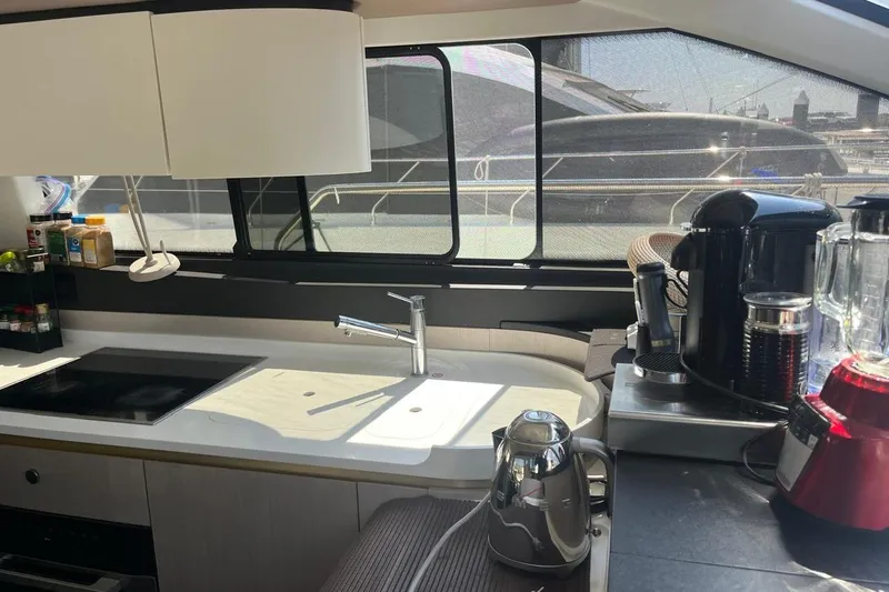 Al&Iacute;a Yacht Photos Pics Modern kitchen interior of 2025 Azimut Fly 60 yacht with appliances and sleek design.
