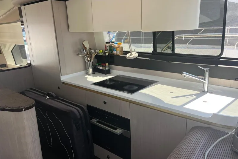 Al&Iacute;a Yacht Photos Pics Modern kitchen interior of 2025 Azimut Fly 60 yacht with sleek design and appliances.
