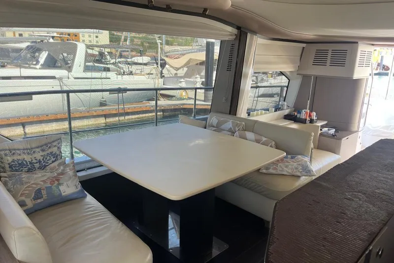 Al&Iacute;a Yacht Photos Pics Luxurious interior of 2025 Azimut Fly 60 yacht with elegant dining area.
