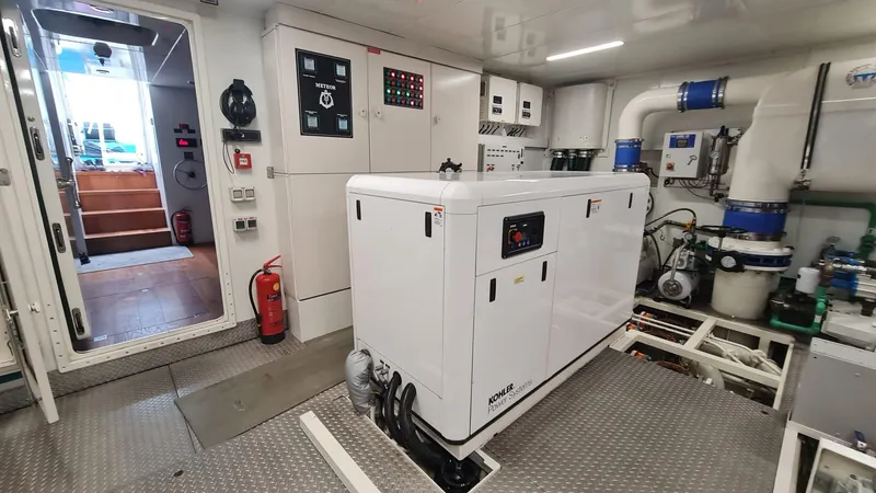  Yacht Photos Pics Engine room of a 2018 Custom 46 M yacht, featuring modern equipment and control panels.