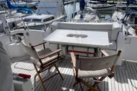 Luxury yacht deck with seating area, table, and marina view. Trader 42, 2007 model.