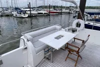 Luxurious 2007 Trader 42 yacht with elegant seating and table, docked at a marina.