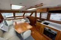Luxurious interior of a 2007 Trader 42 yacht with wood finishes and modern amenities.