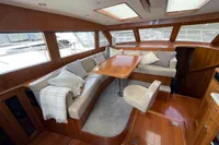 Luxurious interior of a 2007 Trader 42 yacht with elegant seating and wooden finishes.