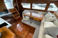 Luxurious interior of a 2007 Trader 42 yacht with elegant wood finishes and plush seating.