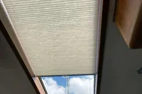 Skylight with partially open blind on a 2007 Trader 42 boat, showing blue sky.