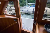 Interior view of 2007 Trader 42 yacht, showing wooden finish and marina outside.