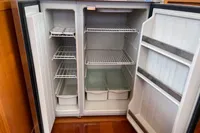 Open refrigerator with empty shelves and drawers, Trader 42 model, 2007.