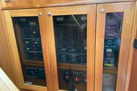 Electrical control panel on a 2007 Trader 42 boat with wooden cabinet.