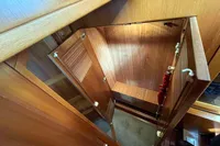 Wooden interior of 2007 Trader 42 yacht, featuring a compact storage area.
