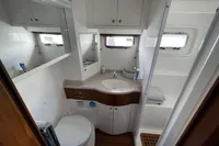 Compact bathroom in a 2007 Trader 42 yacht, featuring modern fixtures and ample storage.