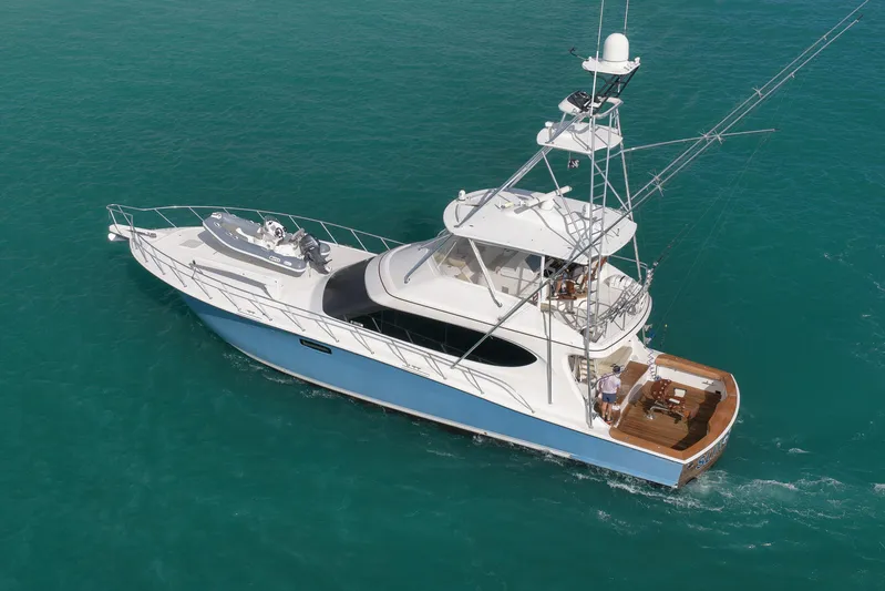 "slim Shady" Yacht Photos Pics 2015 Hatteras GT70 yacht cruising on clear blue water, aerial view.