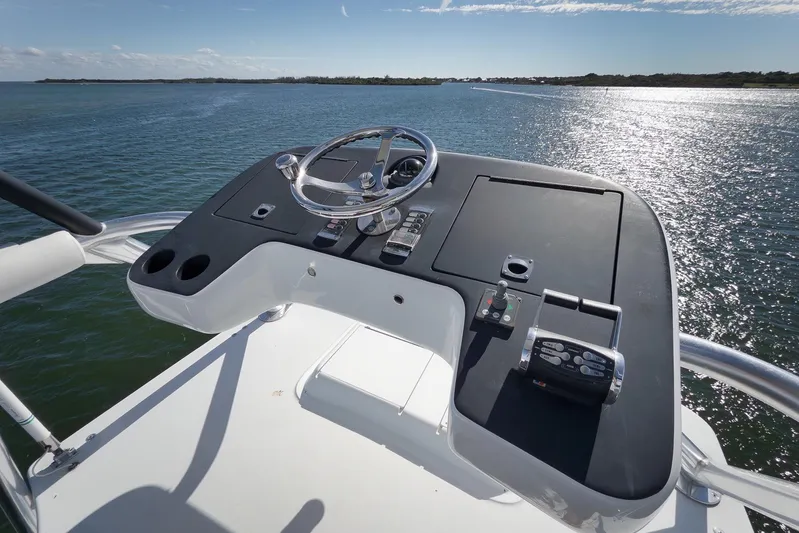 "slim Shady" Yacht Photos Pics Helm of 2015 Hatteras GT70 yacht overlooking serene water and distant shoreline.