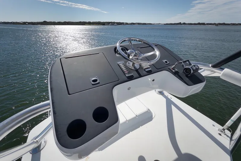 "slim Shady" Yacht Photos Pics Helm of 2015 Hatteras GT70 yacht overlooking serene water.