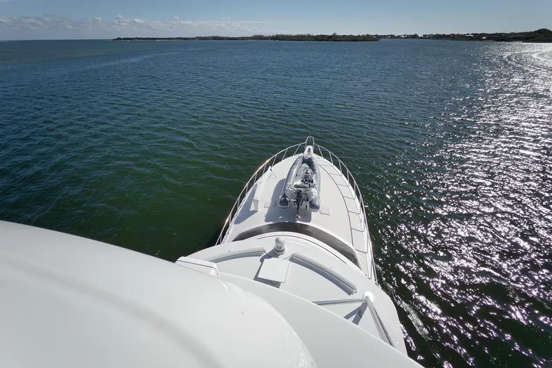 "slim Shady" Yacht Photos Pics 2015 Hatteras GT70 yacht cruising on open water under clear skies.