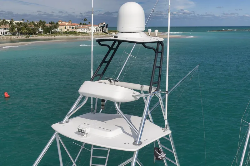 "slim Shady" Yacht Photos Pics 2015 Hatteras GT70 yacht tower overlooking turquoise ocean and coastal homes.