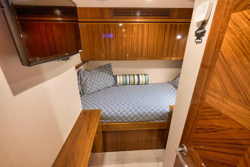 "slim Shady" Yacht Photos Pics Luxurious cabin interior of 2015 Hatteras GT70 yacht with wood finishes and cozy bedding.