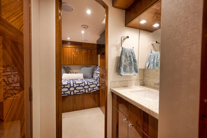 "slim Shady" Yacht Photos Pics Luxurious interior of 2015 Hatteras GT70 yacht featuring bedroom and bathroom.