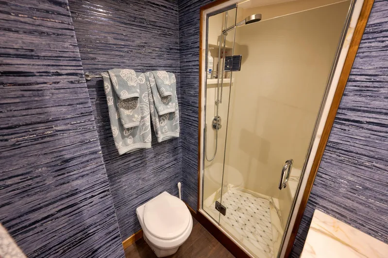 "slim Shady" Yacht Photos Pics Luxurious bathroom in 2015 Hatteras GT70 yacht with modern shower and elegant decor.