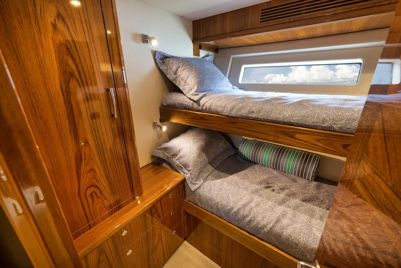 "slim Shady" Yacht Photos Pics Luxurious wooden cabin with bunk beds in 2015 Hatteras GT70 yacht.