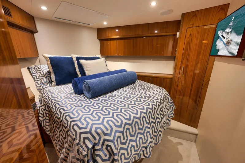 "slim Shady" Yacht Photos Pics Luxurious cabin interior of 2015 Hatteras GT70 yacht with elegant bedding and wood finishes.