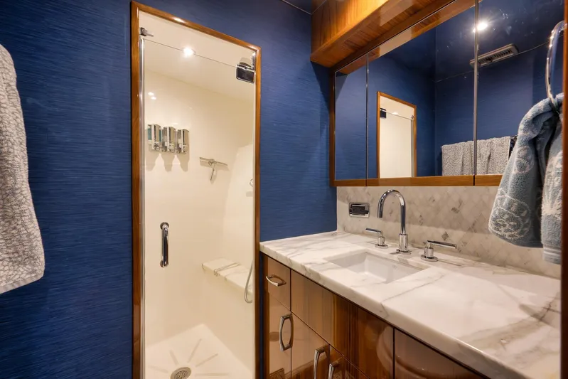 "slim Shady" Yacht Photos Pics Luxurious bathroom in 2015 Hatteras GT70 yacht with marble countertop and glass shower.