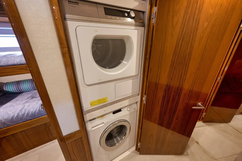 "slim Shady" Yacht Photos Pics Laundry area with Miele appliances on 2015 Hatteras GT70 yacht.