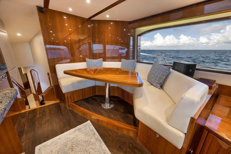 "slim Shady" Yacht Photos Pics Luxurious 2015 Hatteras GT70 yacht interior with elegant wood finish and ocean view.