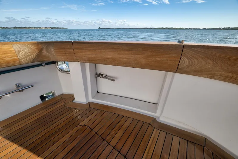 "slim Shady" Yacht Photos Pics 2015 Hatteras GT70 yacht deck with wooden finish, overlooking serene ocean view.