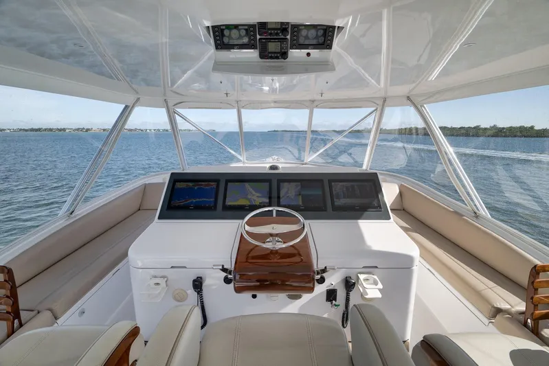 "slim Shady" Yacht Photos Pics Helm of 2015 Hatteras GT70 yacht with navigation screens and panoramic ocean view.