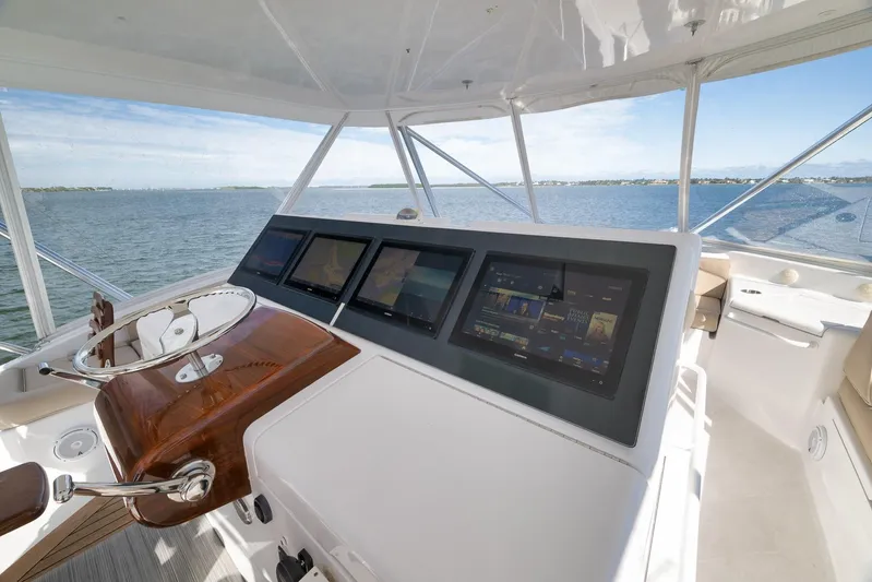 "slim Shady" Yacht Photos Pics Helm of 2015 Hatteras GT70 yacht with modern navigation screens and ocean view.