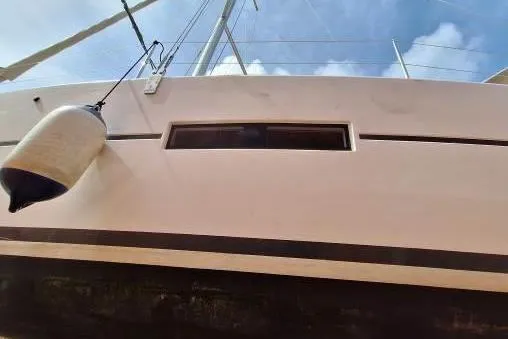 Bermuda Yacht Photos Pics 2017 Dufour 412 Grand Large sailboat, side view with fender, under clear sky.