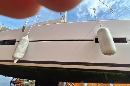 Bermuda Yacht Photos Pics Dufour 412 Grand Large 2017 sailboat with fenders, docked under a clear sky.