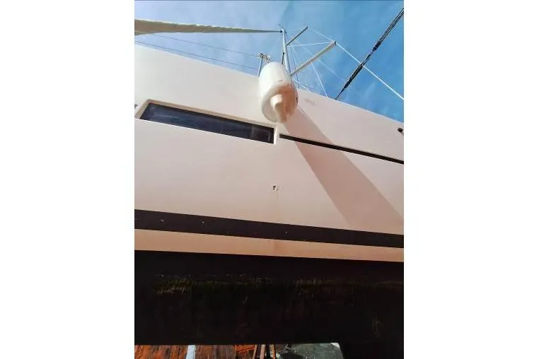 Bermuda Yacht Photos Pics 2017 Dufour 412 Grand Large sailboat, side view with fender, against blue sky.