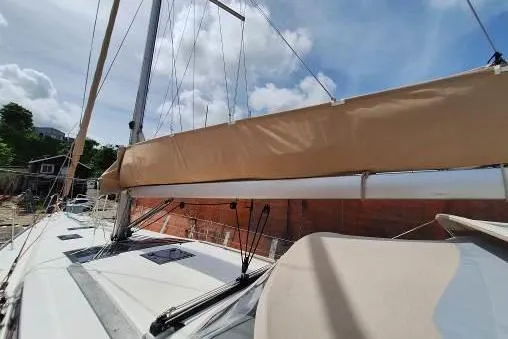 Bermuda Yacht Photos Pics 2017 Dufour 412 Grand Large sailboat with beige sail cover under blue sky.