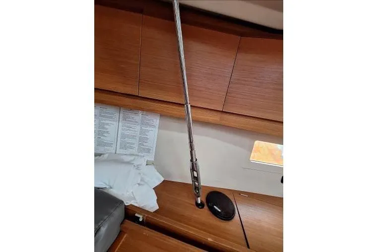 Bermuda Yacht Photos Pics Interior of 2017 Dufour 412 Grand Large yacht with wooden cabinetry and metal support rod.