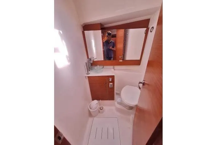 Bermuda Yacht Photos Pics 2017 Dufour 412 Grand Large yacht bathroom with mirror, sink, and toilet.