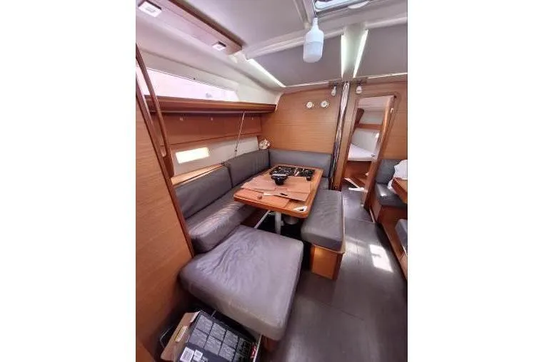 Bermuda Yacht Photos Pics Interior of 2017 Dufour 412 Grand Large yacht with cozy seating and wooden finishes.