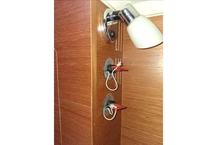 Bermuda Yacht Photos Pics Interior light switches on 2017 Dufour 412 Grand Large yacht with wooden paneling.