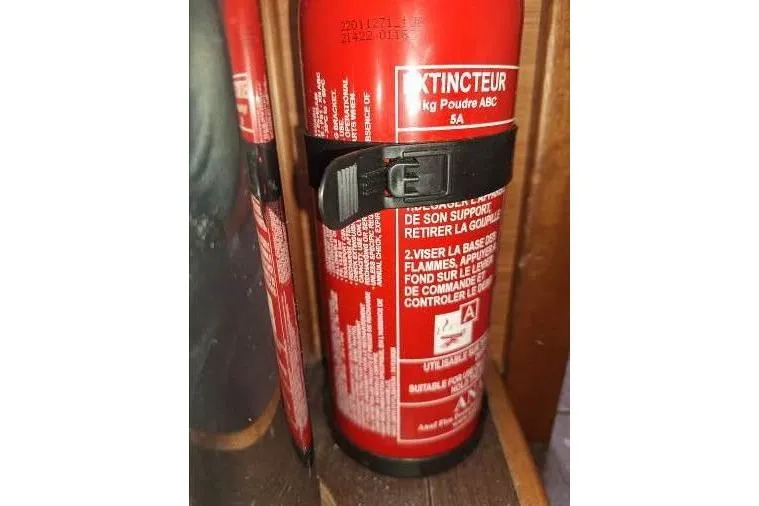 Bermuda Yacht Photos Pics Red fire extinguisher on Dufour 412 Grand Large 2017 yacht, secured with a black strap.