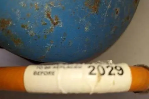 Bermuda Yacht Photos Pics Rusty blue surface with an expiration label marked "2029," Dufour 412 Grand Large, 2017.