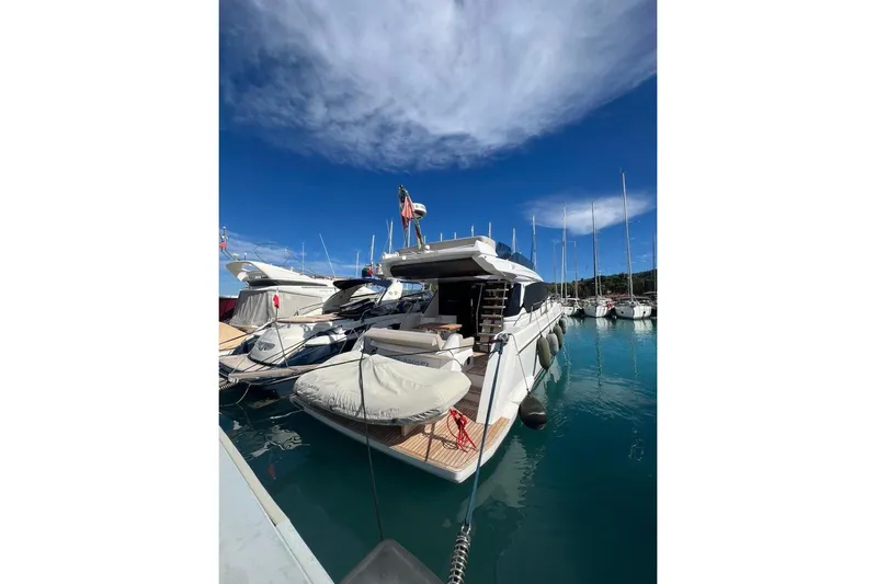  Yacht Photos Pics 2023 Ferretti 500 yacht docked in a marina under a clear blue sky.