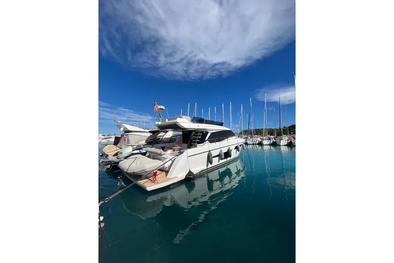  Yacht Photos Pics 2023 Ferretti 500 yacht docked in a marina under a clear blue sky.