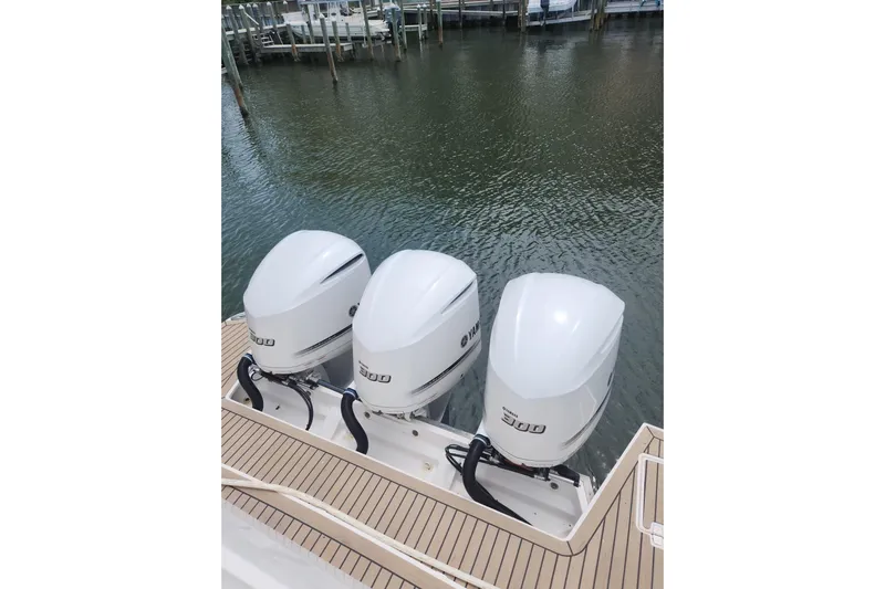  Yacht Photos Pics Triple Yamaha 300 outboard engines on 2020 Regal 38 XO boat, docked by water.