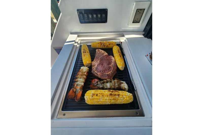  Yacht Photos Pics Grilled steak, lobster tails, and corn on Regal 38 XO yacht's outdoor grill.